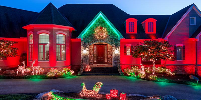 wireless outdoor lighting with Christmas colors on luxury home