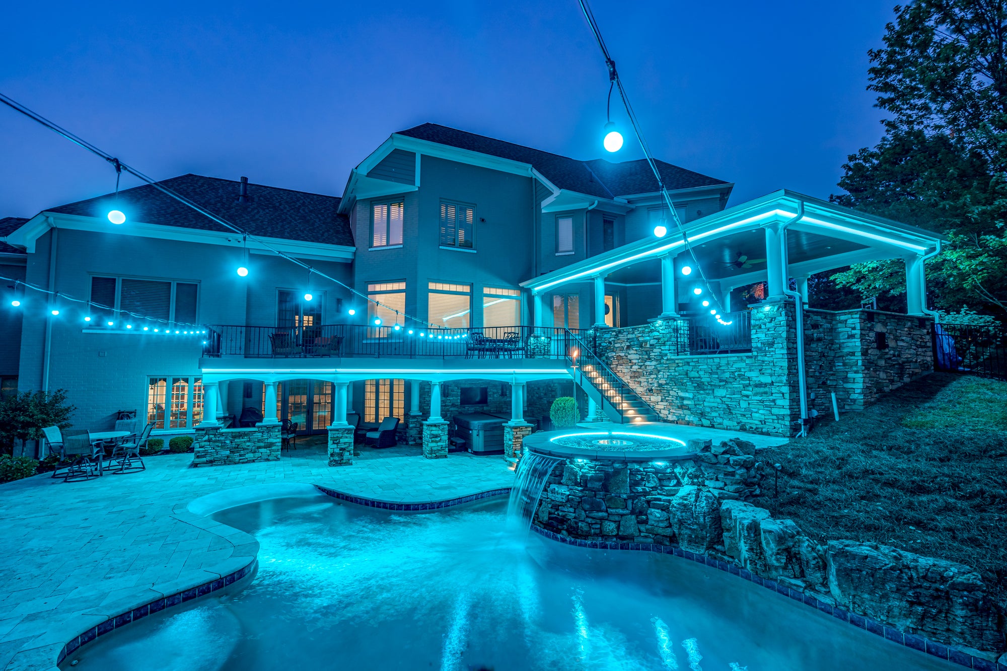 Outdoor and pool with (blue) colorful bistro lights.